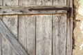 Locked old wooden door of a rural barn. Texture of a wooden board and rusty iron staples. Closed door of an ancient Royalty Free Stock Photo