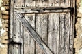 Locked old wooden door of a rural barn. Texture of a wooden board and rusty iron staples. Closed door of an ancient Royalty Free Stock Photo