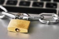 Locked padlock with ametallic chain on a laptop keyboard. Cyber safety concept Royalty Free Stock Photo