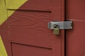 Locked padlock with chain at colorful wooden door Royalty Free Stock Photo