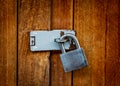 Locked padlock with chain at wooden door background Royalty Free Stock Photo