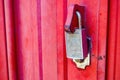a locked padlock on the red iron harmonica door Royalty Free Stock Photo