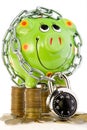 Locked piggy bank on coins Royalty Free Stock Photo