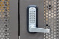 Locked private metal security gate door with push button combination lock system keypad with