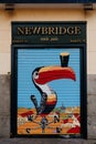 Locked roll-up door painted with the image of a toucan from an Irish pub in Madrid