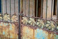 Locked, rusting gate with leaf motif