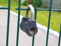 Locked rusty padlock on fence