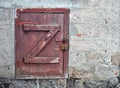 An old battered door against a concrete wall