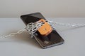 A locked smartphone, wrapped in chains and a lock. Forgotten password Royalty Free Stock Photo