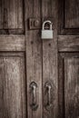 Locked wooden door with silver padlock Royalty Free Stock Photo