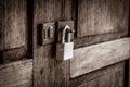 Locked wooden door with silver padlock Royalty Free Stock Photo