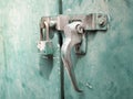 Locking handing with door blot on green old steel door locker.