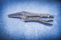Locking pliers with closed jaws on metallic background Royalty Free Stock Photo