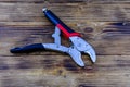 Locking pliers with red handles on a wooden background Royalty Free Stock Photo