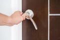 Locking or unlocking door with key by hand Royalty Free Stock Photo