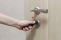 Locking up or unlocking door with key in hand. Royalty Free Stock Photo