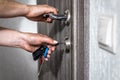 Locking up or unlocking entrance door with key in hand Royalty Free Stock Photo