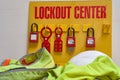 Lockout/tagout station with hard hat and vest on white background