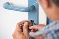 Lockpicker Fixing Door Handle At Home Royalty Free Stock Photo