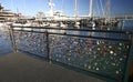 Padlocks of love on metal guardrail at marina with sailboats in Silo Park, Auckland, New Zealand Royalty Free Stock Photo