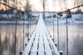 Locks on a rope bridge over frozen water Royalty Free Stock Photo