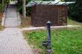 Locks of a tool house in a large public park. serves as a public toilet. It has brown wood paneling and a glass roof with overlaps