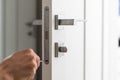 A locksmith repair the door lock in the room or handyman install the new door lock in the room Royalty Free Stock Photo