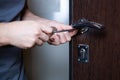 Locksmith replacing door lock to new after losing keys. Robbery protection, safety improvement. Repairman or workman Royalty Free Stock Photo