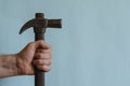 Locksmith`s hand holds a vintage hammer with a claw hammer Royalty Free Stock Photo