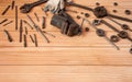 Locksmith vises, dies and taps of different diameters, a	pipe wrench and work gloves on a wooden background. Royalty Free Stock Photo