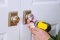 Worker installing a new dummy lock in house on door Royalty Free Stock Photo