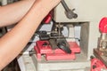 Locksmith in workshop makes new key. Professional making key in locksmith Royalty Free Stock Photo