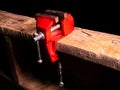 Locksmiths tool metal vise fixed on a wooden table Royalty Free Stock Photo