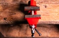 Locksmiths tool metal vise fixed on a wooden table Royalty Free Stock Photo