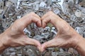 Locksmiths use their hands to make heart symbols on a blurry background of a large number of keys to show their love and care in