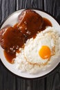 Loco moco is a dish featured in contemporary Hawaiian cuisine consists of white rice, topped with a hamburger, a fried egg, and Royalty Free Stock Photo