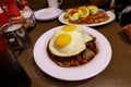 Loco Moco , traditional Hawaiian cuisine , burger patty on rice with a fried egg and brown gravy sauce