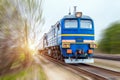 Locomotive in the composition of a passenger train in motion at speed. Royalty Free Stock Photo