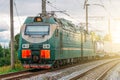 Locomotive electric with a freight train at high speed rides by rail. Royalty Free Stock Photo