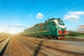 Locomotive electric with a freight train at high speed rides by rail road. Royalty Free Stock Photo