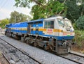 A locomotive engine parked on a track in Mysore Railway Station