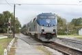 Locomotive pulling carriages over level crossing