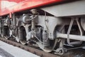 Locomotive on railway station, iron train wheels mechanism close up, steel rail wheel construction, railroad wagon part Royalty Free Stock Photo