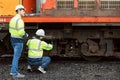 Locomotive repair worker, Train Engineer technician on duty working Maintenance Rolling Stocks of old diesel train passenger cabin Royalty Free Stock Photo