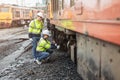 Locomotive repair worker, Train Engineer technician on duty working Maintenance Rolling Stocks of old diesel train passenger cabin Royalty Free Stock Photo