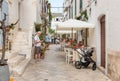 Tourists enjoying the outdoor restaurants in the ancient village Locorotondo, in province of Bari, Italy