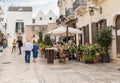 Tourists enjoying the outdoor restaurants in the ancient village Locorotondo, in province of Bari, Italy