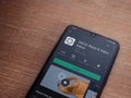 VSCO - Photo and Video Editor app play store page on mobile smartphone on wooden background