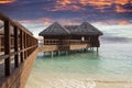 Lodges over water at the time sunset. Maldives.