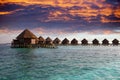 Lodges over water at the time sunset. Maldives.